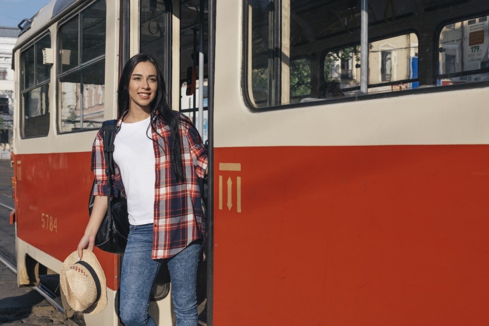 a person standing in front of a bus
